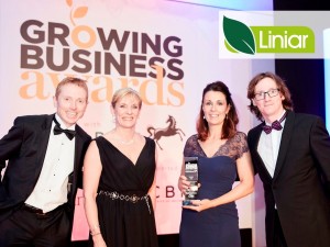 Sue and Emma collect the award from Andrew Connors, Lloyds and comedian Ed Byrne