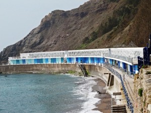 Beach huts in Torquay show new coats of blue paint