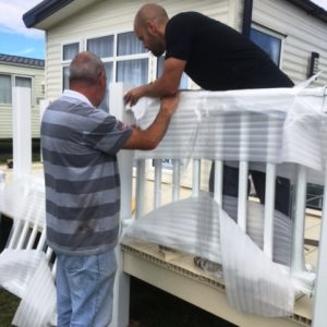 Balustrades being installed on a cream uPVC deck