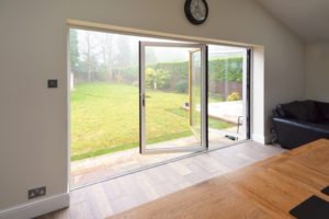 Looking from the outside in through an Alumina bi-fold door installed by Silika Ltd