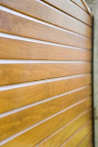 Close up image of the golden oak foil on Liniar's fence panels