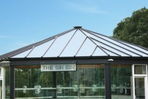 Glazed walls and roof with metal beams and transitional bars in the glazed roof of the Peterborough RUFC