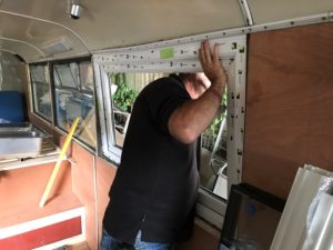 Liniar uPVC window being fit into the side of a bus