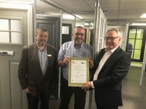 Liam Gilsenan (right) of CORGI Fenestration presents Jim Corby and Steve Milham with their certificate, making them the first Liniar fabricator to take advantage of the new scheme