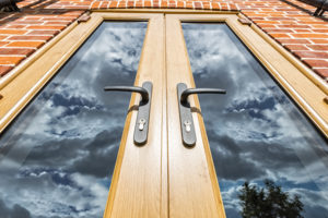 Irish Oak foiled uPVC doors installed in a red brick property 