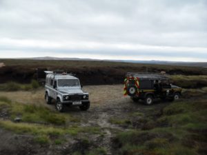 Two Land Rovers on the top of the moors in Derbyshire 