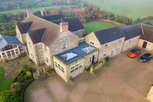 Aerial view of two elevate lantern roofs installed into a stone property in Derbyshire