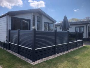 Holiday home deck with privacy and glass panels with balustrade