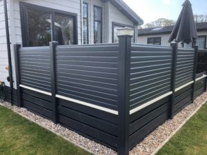 Liniar 7016 grey privacy fencing as privacy panels around a holiday home deck.