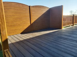 golden oak privacy fencing and balustrades with Liniar's PVCu decking